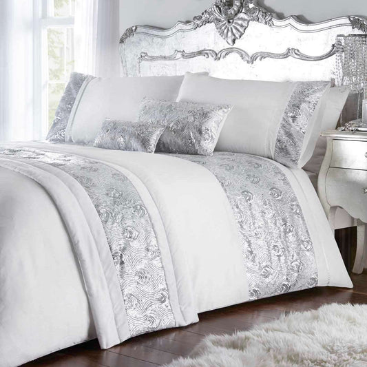 With the contemporary ‘on trend’ shades of metallic white and silver, Krista glitters in shimmering sequins in a peacock feather inspired pattern. The boudoir cushion perfectly accessorises with the bed runner and duvet cover to enhance the glamorous look.