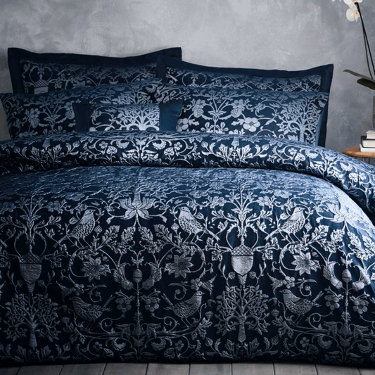 Featuring hand-drawn natural elements and simple woodblock shapes all produced in a high quality woven relief jacquard in a deep Navy colour palette